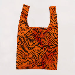 Reusable shopping bag with orange and black abstract pattern on a white background