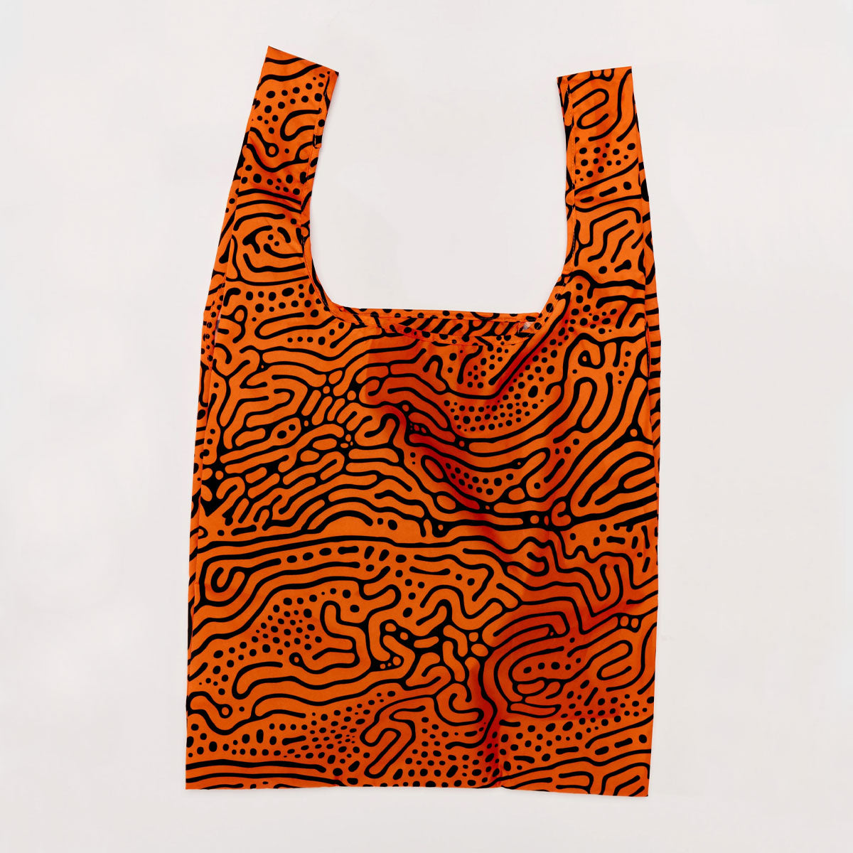 Reusable shopping bag with orange and black abstract pattern on a white background
