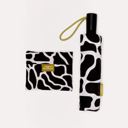 Black and white patterned umbrella and matching pouch with 'original duckhead' label on a light gray background