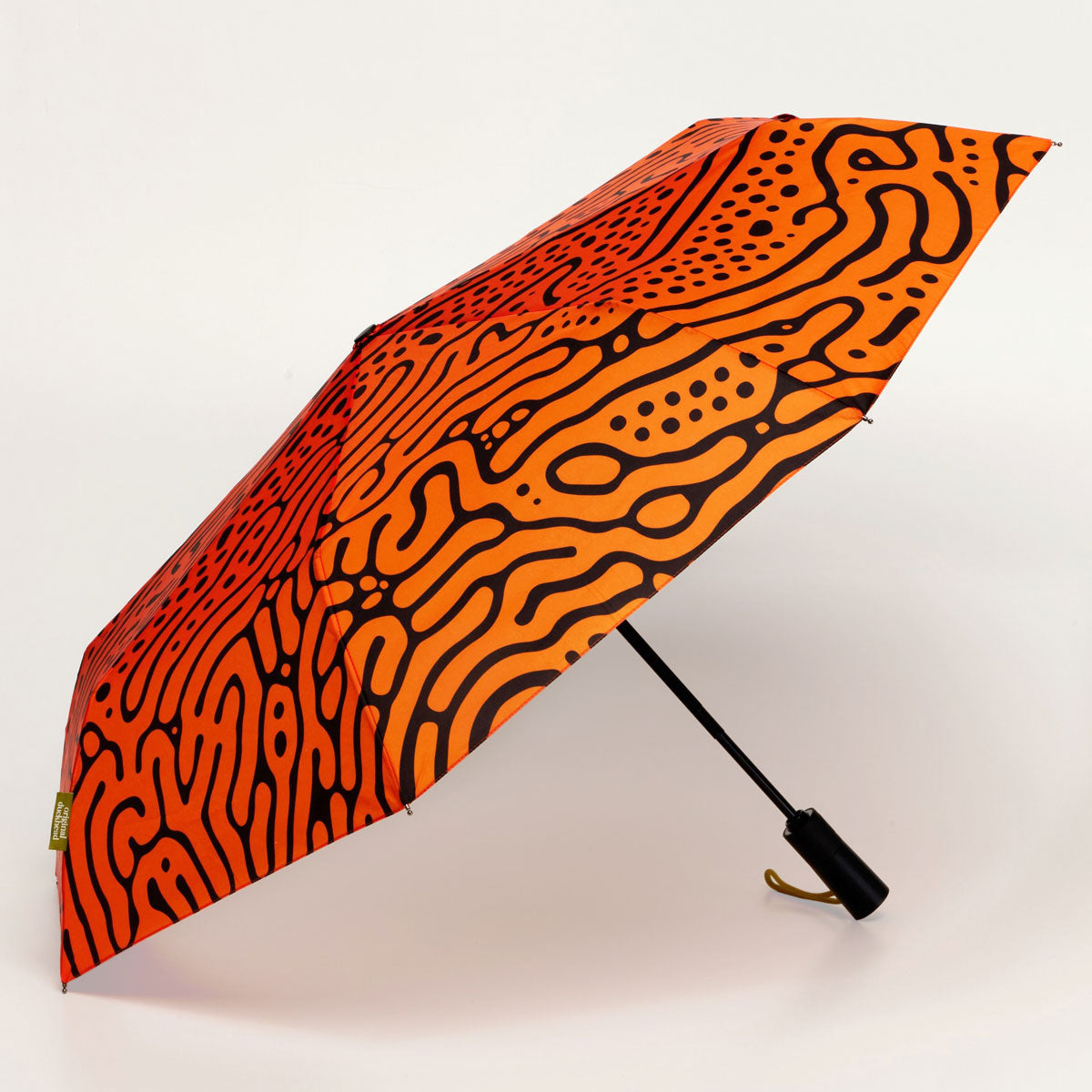 Orange and black patterned umbrella on a white background