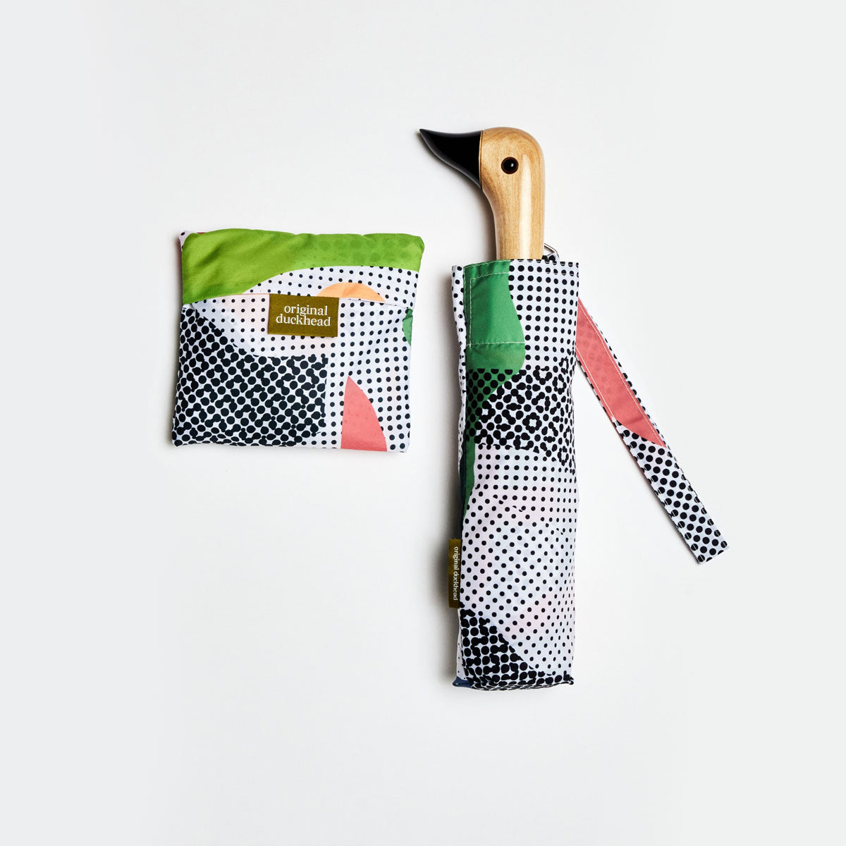 Colorful umbrella with a duckhead wooden handle on a white background