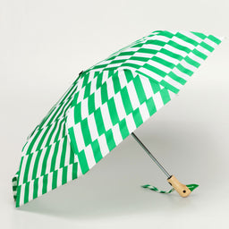 Green and white striped umbrella with a duckhead wooden handle on a light gray background