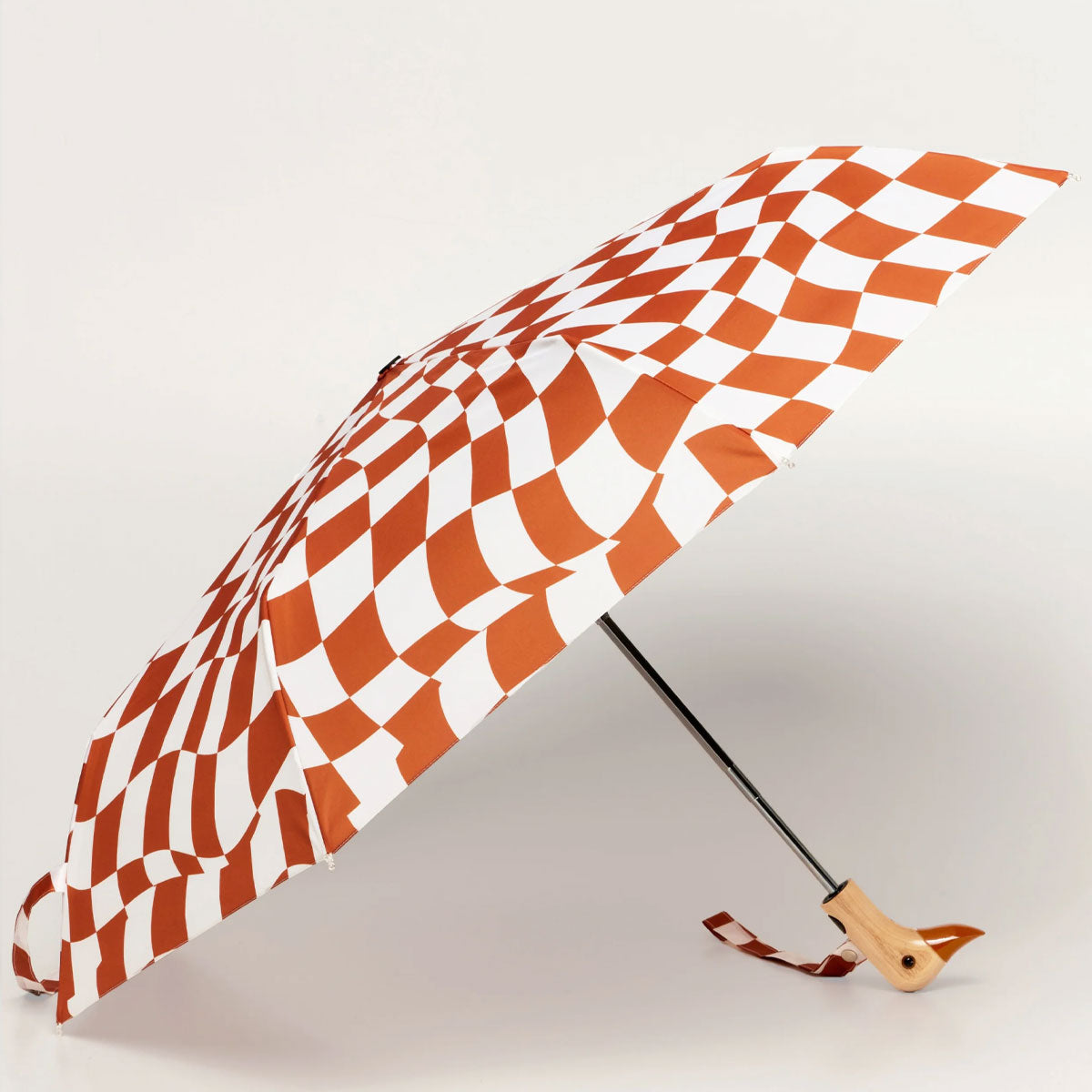 Checkered umbrella with a wooden handle on a light gray background