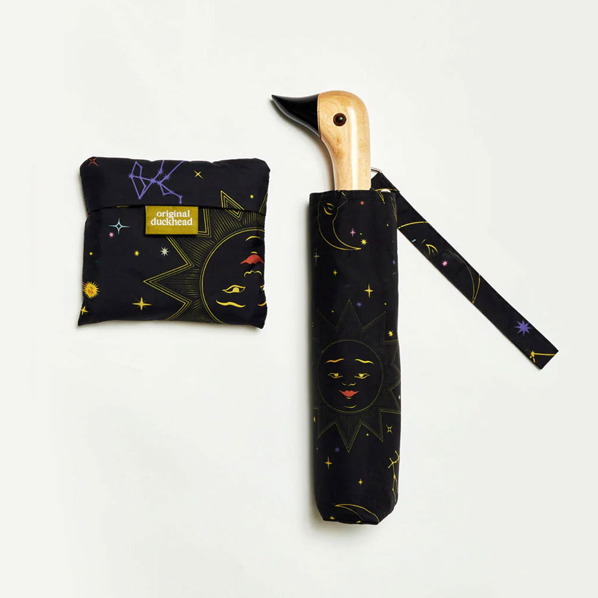 Black umbrella with celestial design and duckhead wooden handle on a white background