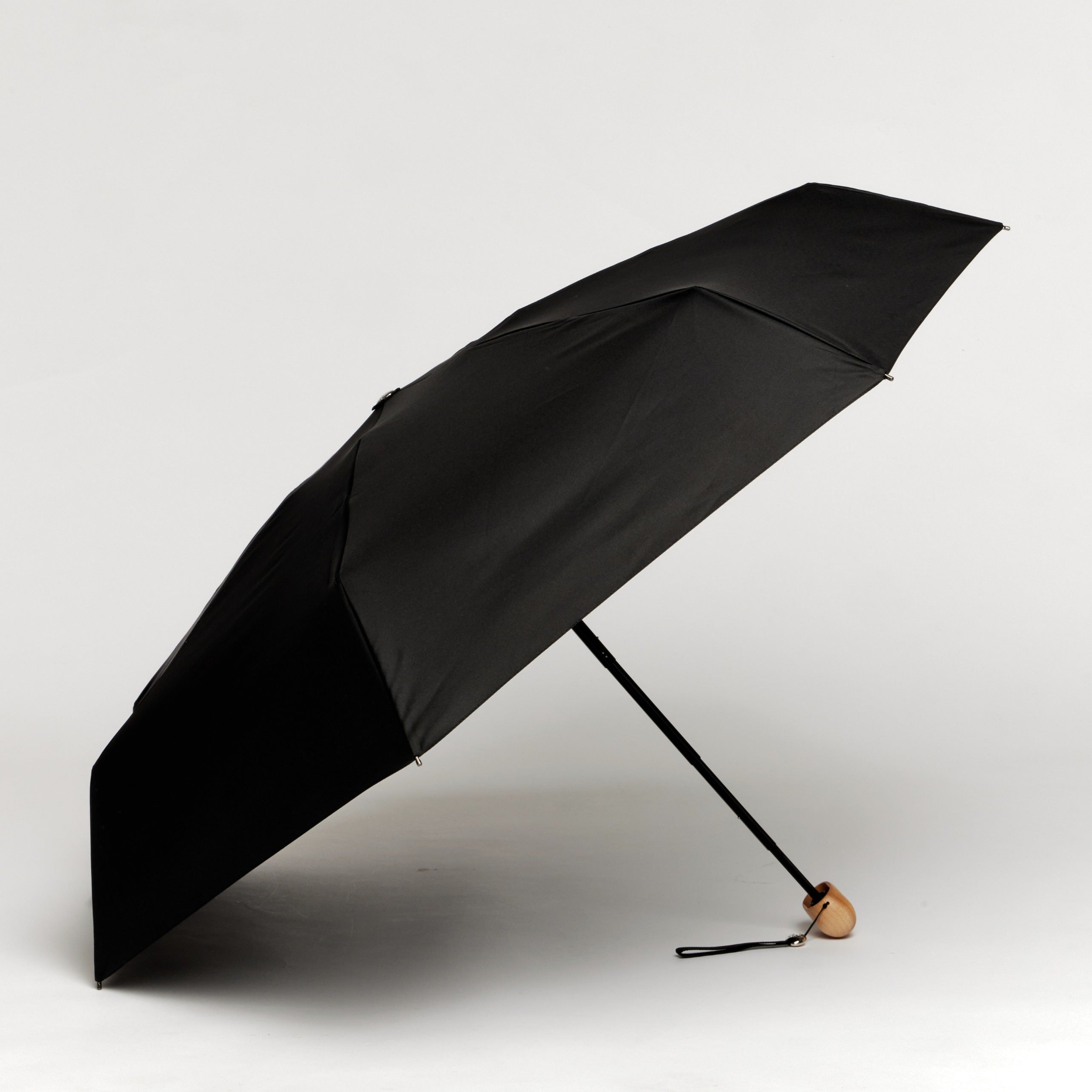 Black umbrella on a light background