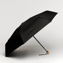 Black umbrella on a light background
