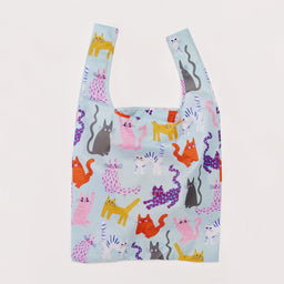 Reusable shopping bag with colorful cat pattern on a light blue background