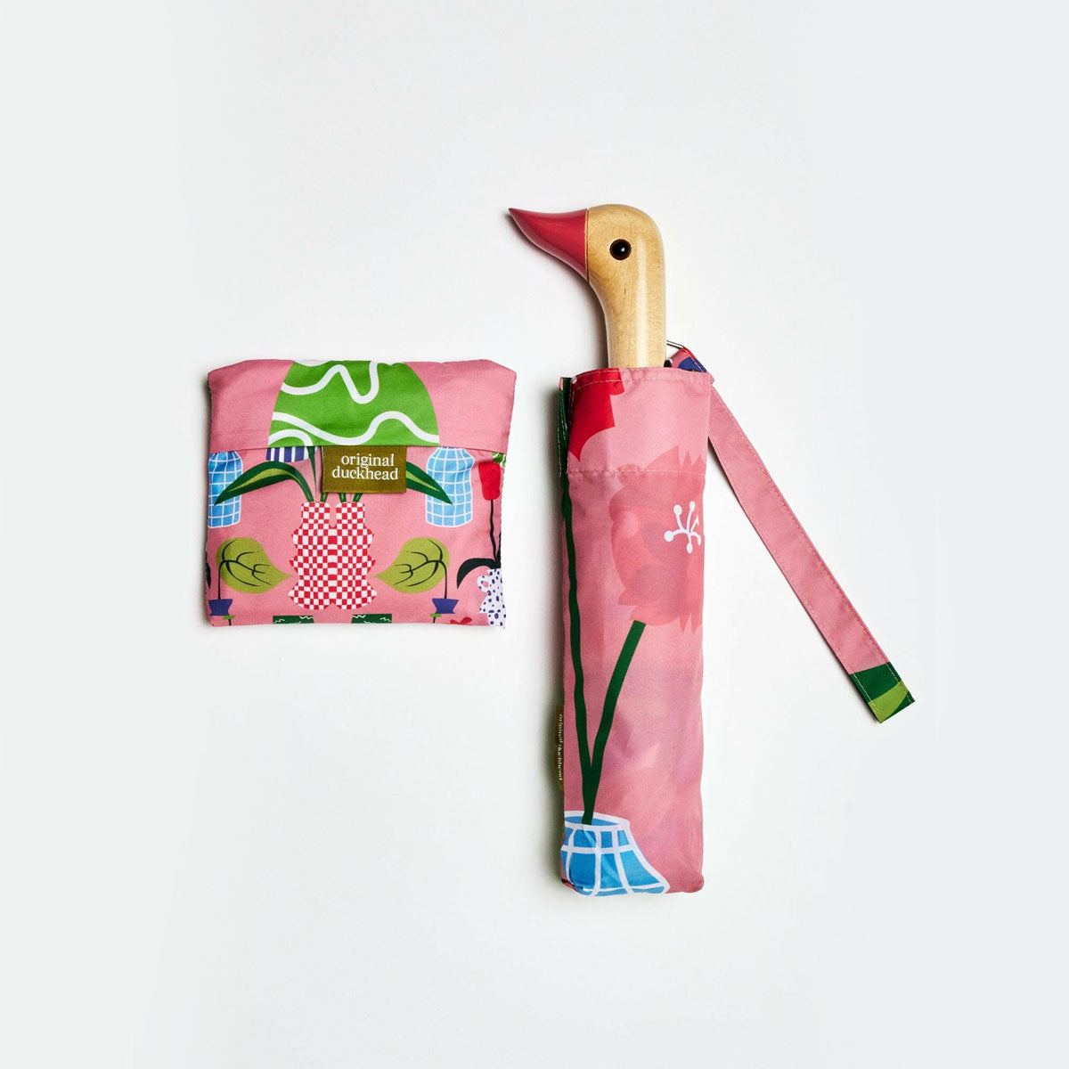 Foldable umbrella with floral design and wooden handle on a white background